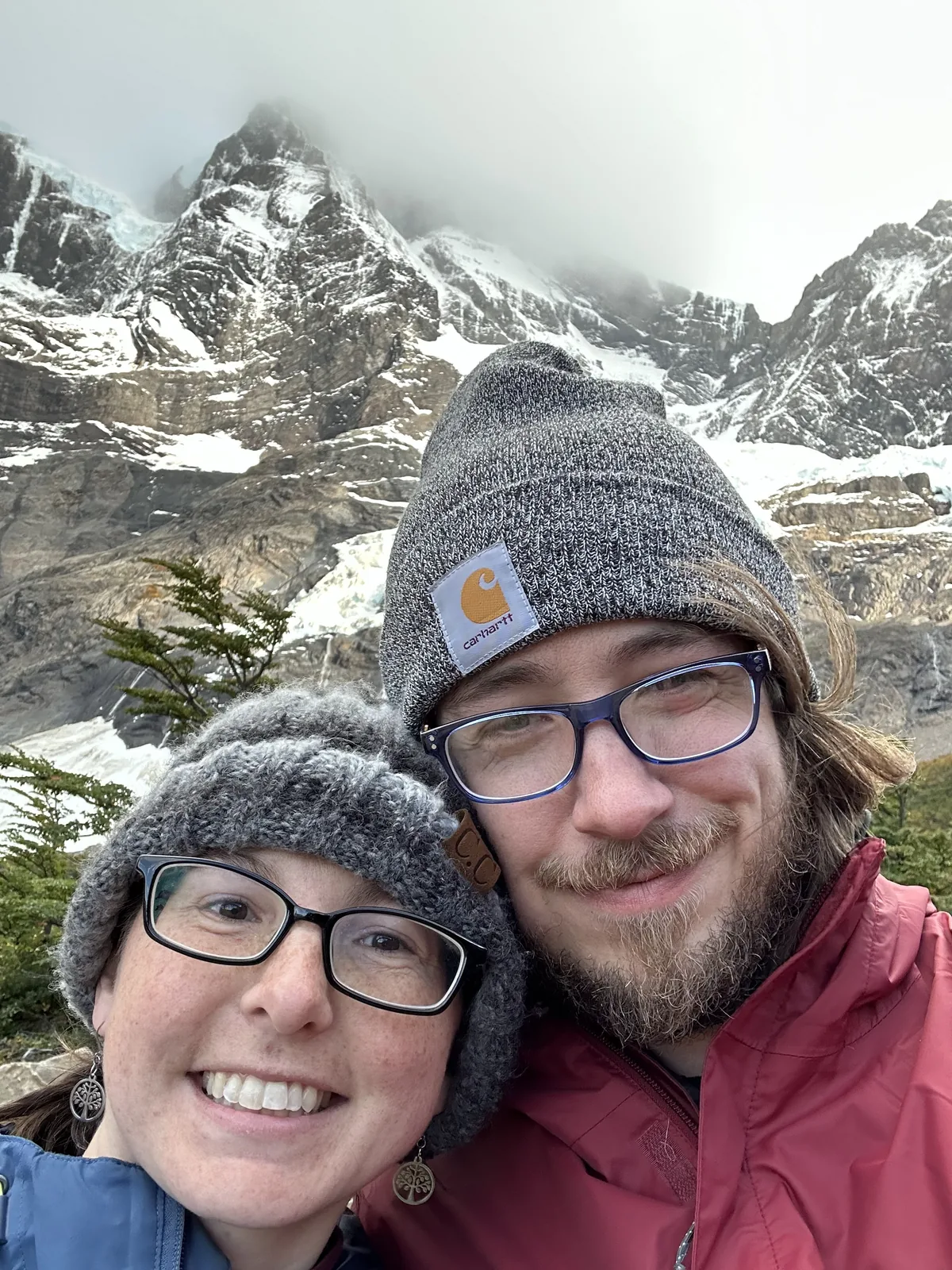 Daniel and Sydney bundled up in front of snowy mountains