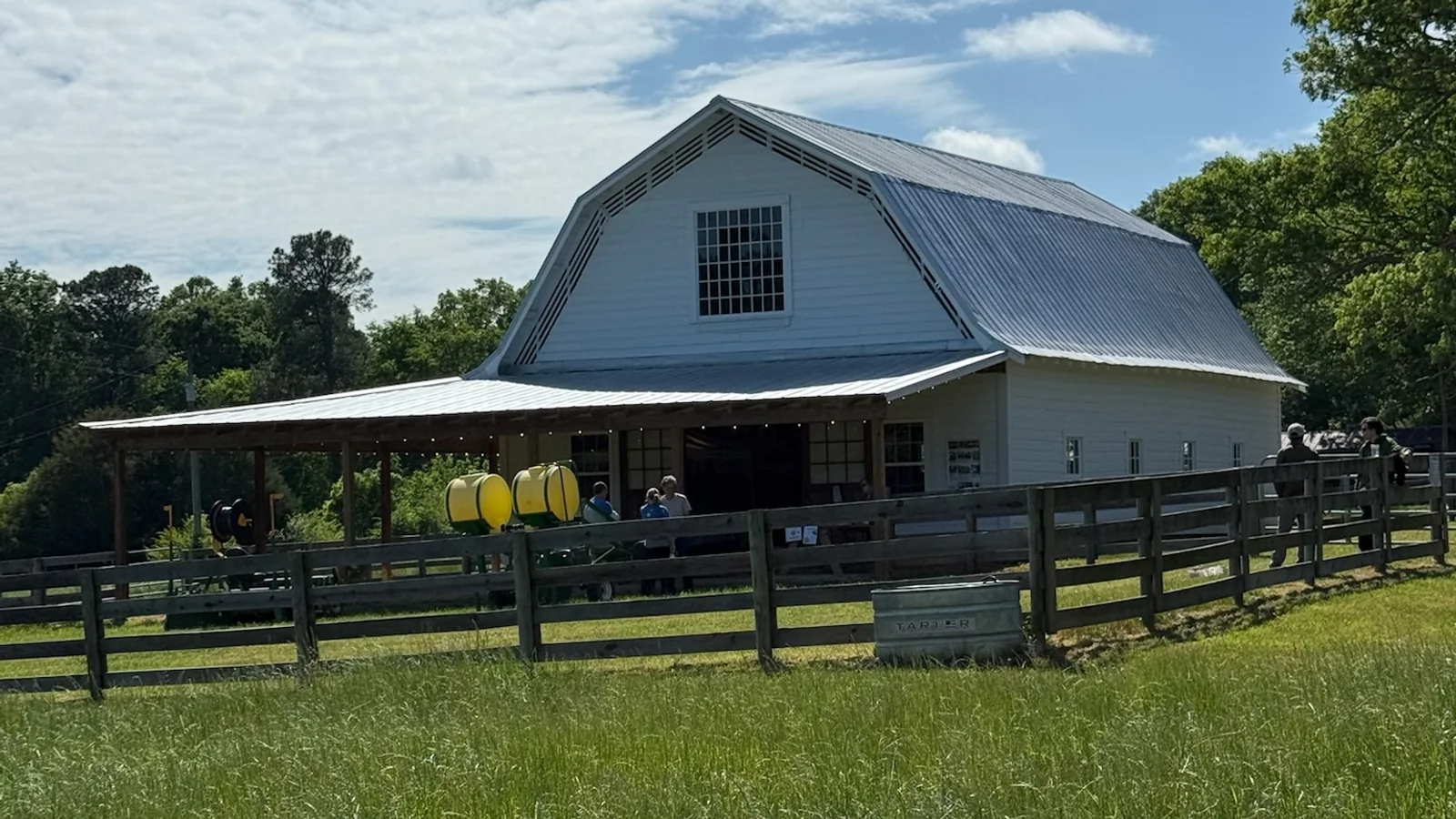 A white barn and open field at Chatham Oaks Farm during the Piedmont Farm Tour in North Carolina.